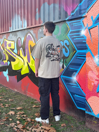Person standing in front of a colorful graffiti wall in taggedstreetwear 