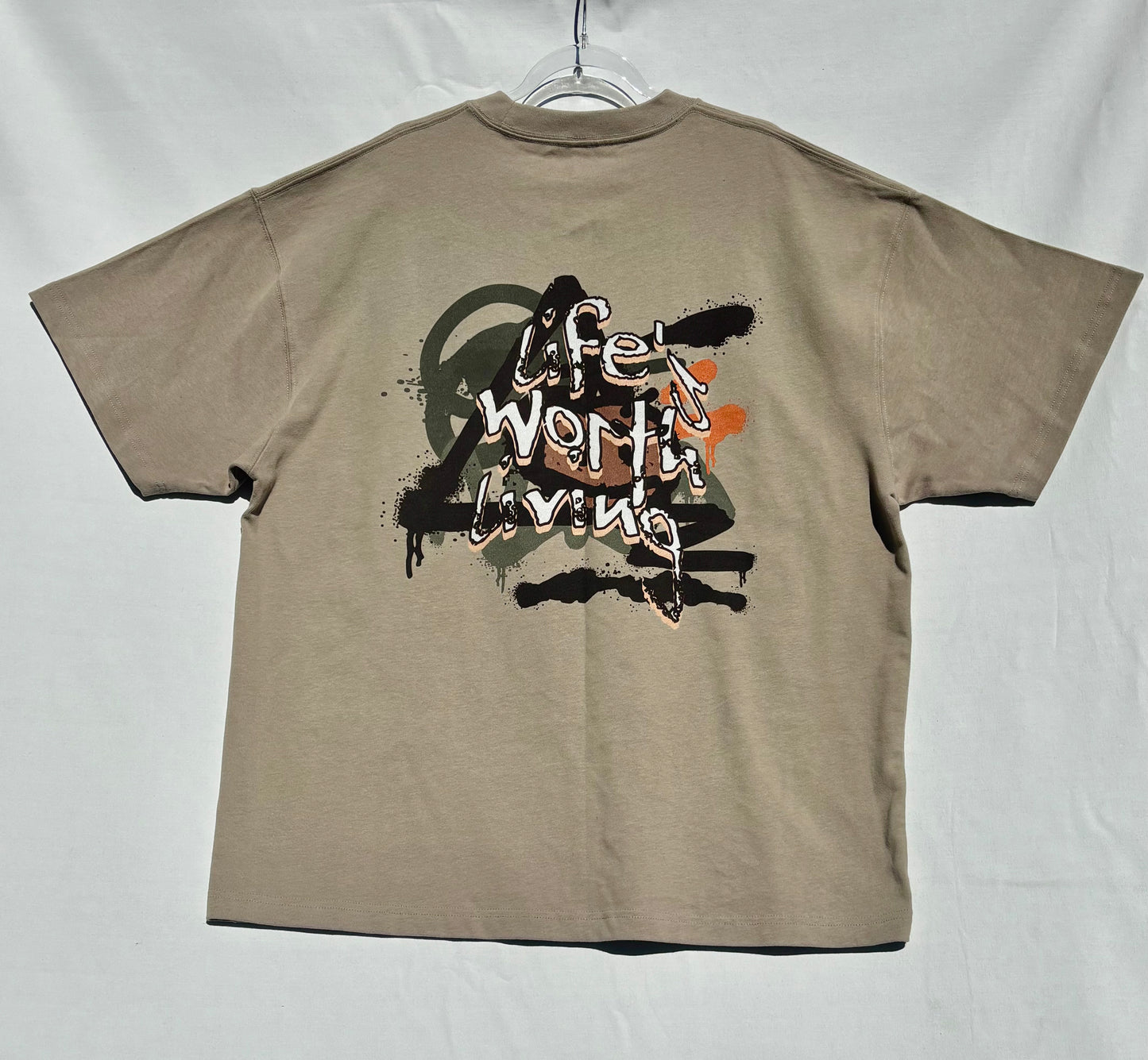 Beige life's worth living t-shirt with graphic design on a white background