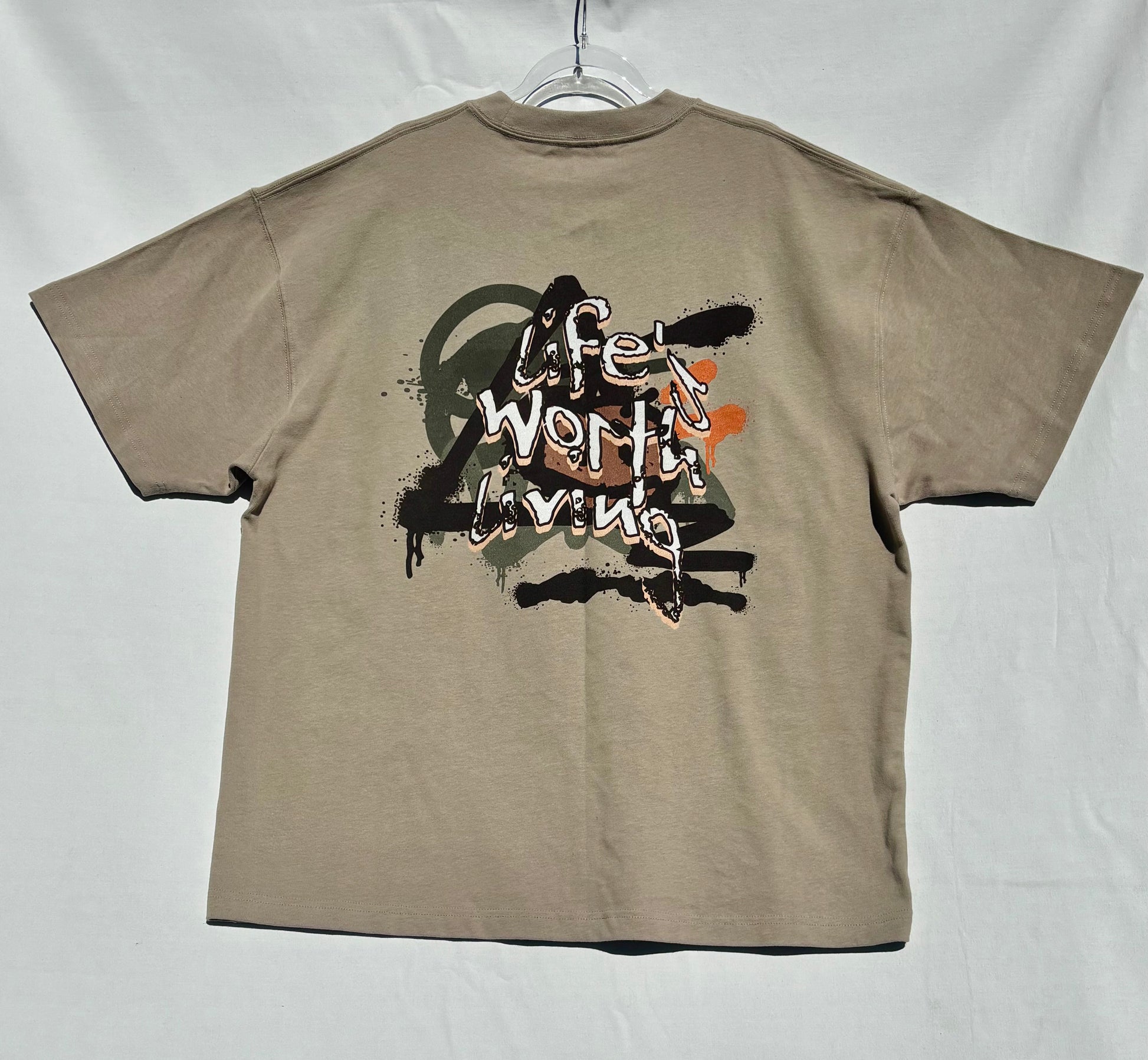 Beige life's worth living t-shirt with graphic design on a white background