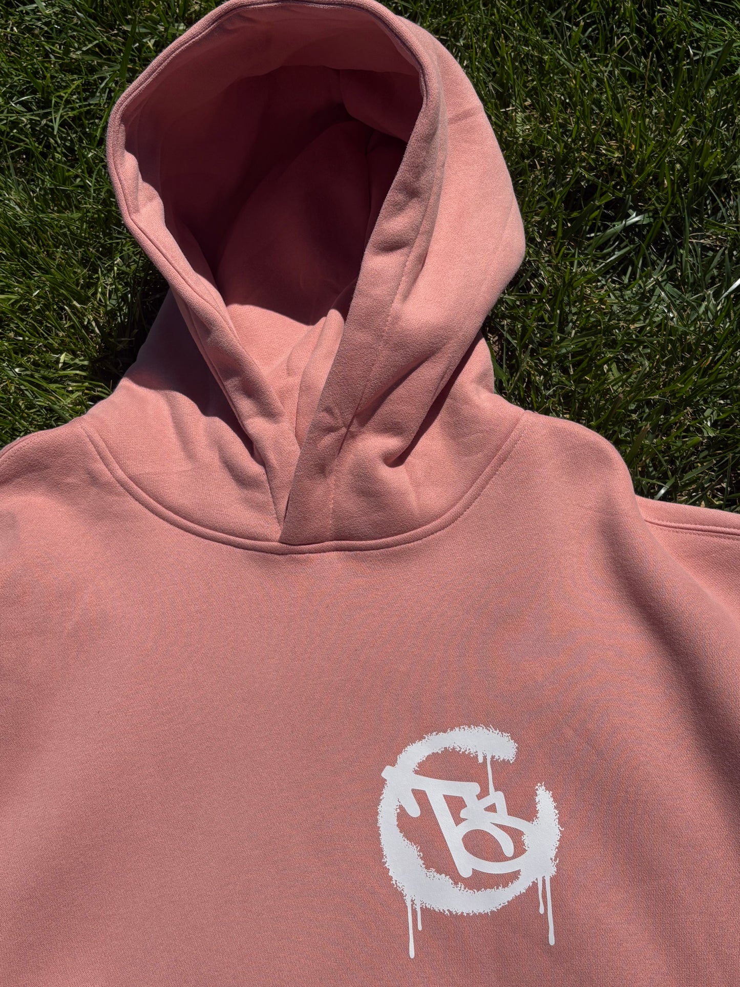 Pink hoodie with a white logo 